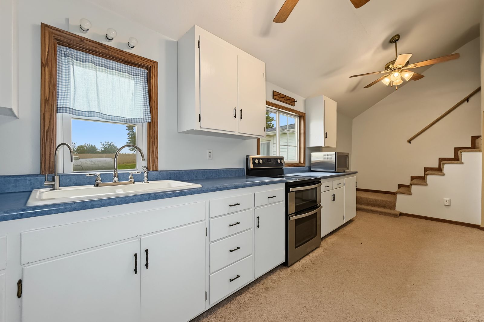 260 County Line Rd, Runnells — Kitchen sink under a window looking out over the property