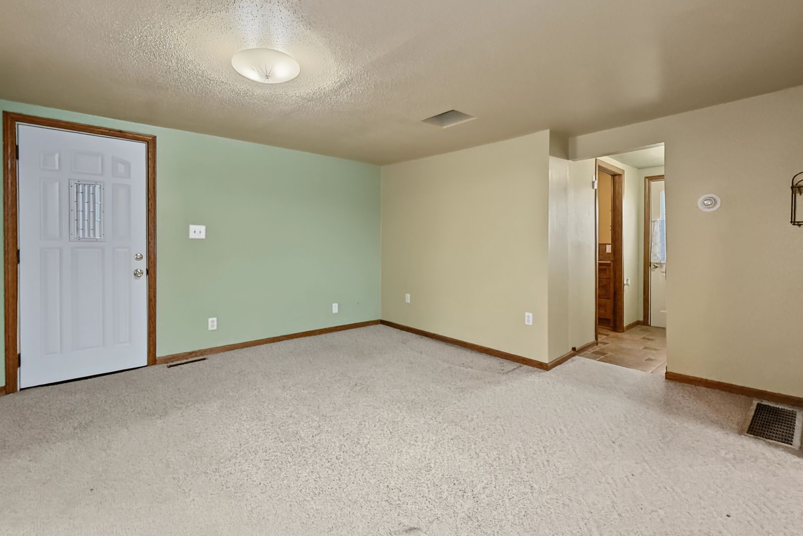 260 County Line Rd, Runnells — Main-floor room with front entry door