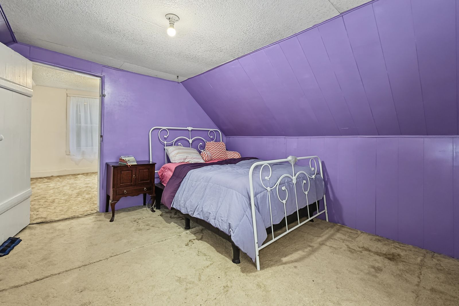 260 County Line Rd, Runnells — Upstairs bedroom under the sloped ceiling
