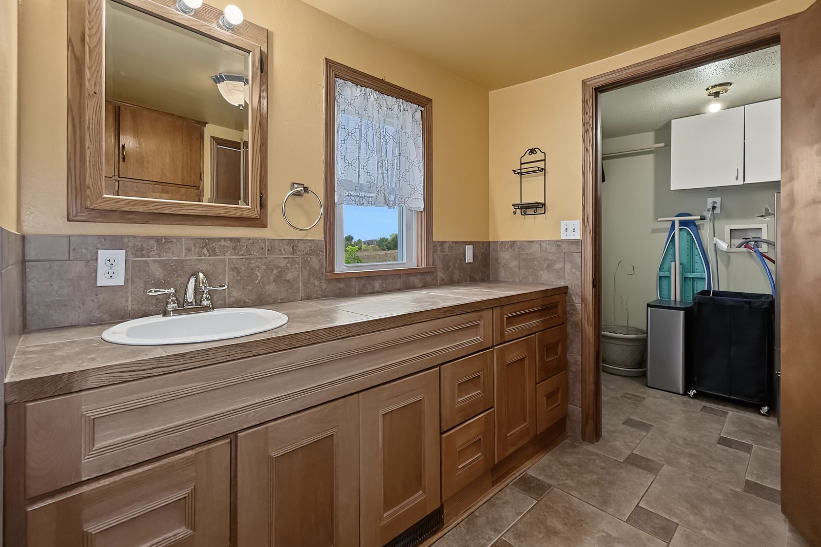 260 County Line Rd, Runnells — Full bath with tiled wainscot and long vanity