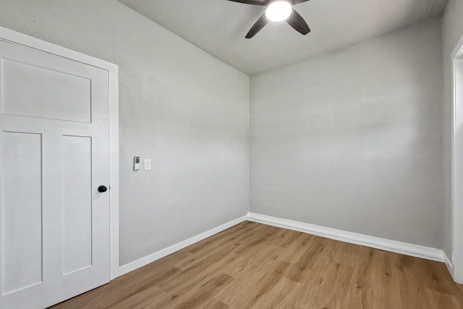 Third bedroom with LVP flooring and ceiling fan in 3-bedroom ranch Des Moines Iowa 50317