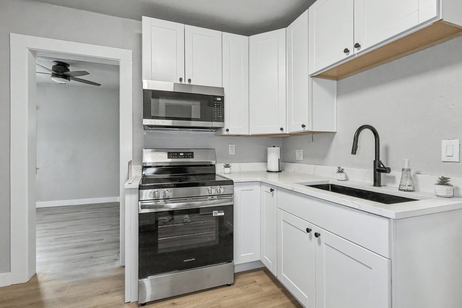 Renovated kitchen with white cabinets quartz countertops stainless appliances at 3436 Scott Ave Des Moines