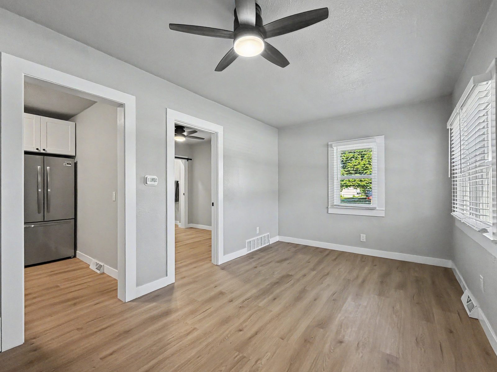 Open living area with LVP flooring and ceiling fan at 3436 Scott Ave Des Moines Iowa