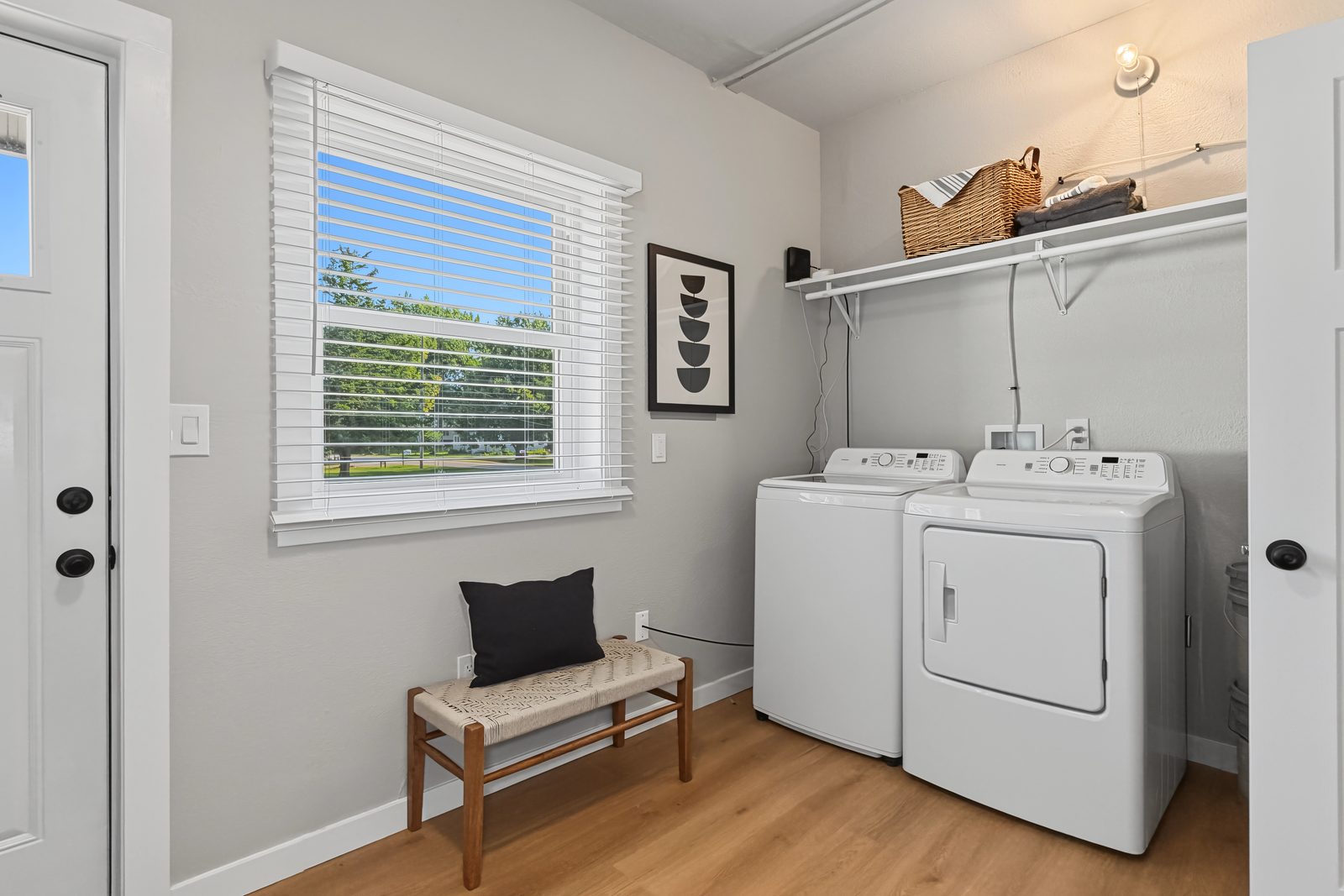 Laundry room with washer, dryer, shelving, and window at 3436 Scott Ave northeast Des Moines Iowa