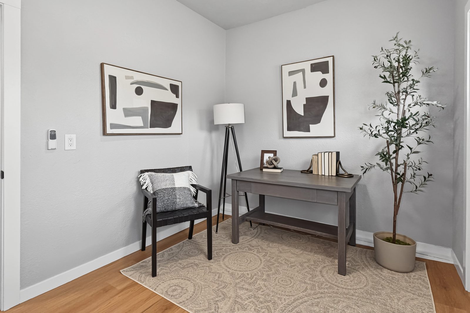 Flex room staged as a home office with desk and reading chair at 3436 Scott Ave Des Moines Iowa